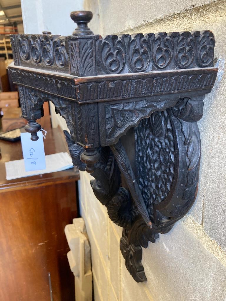 A late 19th century Burmese carved hardwood wall bracket, width 33cm, height 45cm